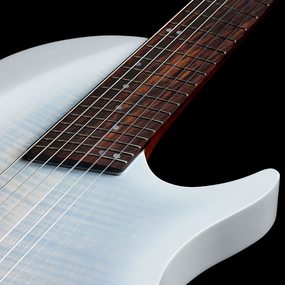 Close-up looking down the Abasi Stage 7 White Burst's neck toward the body, showing the rosewood fretboard's dot markers and the cutaway body.