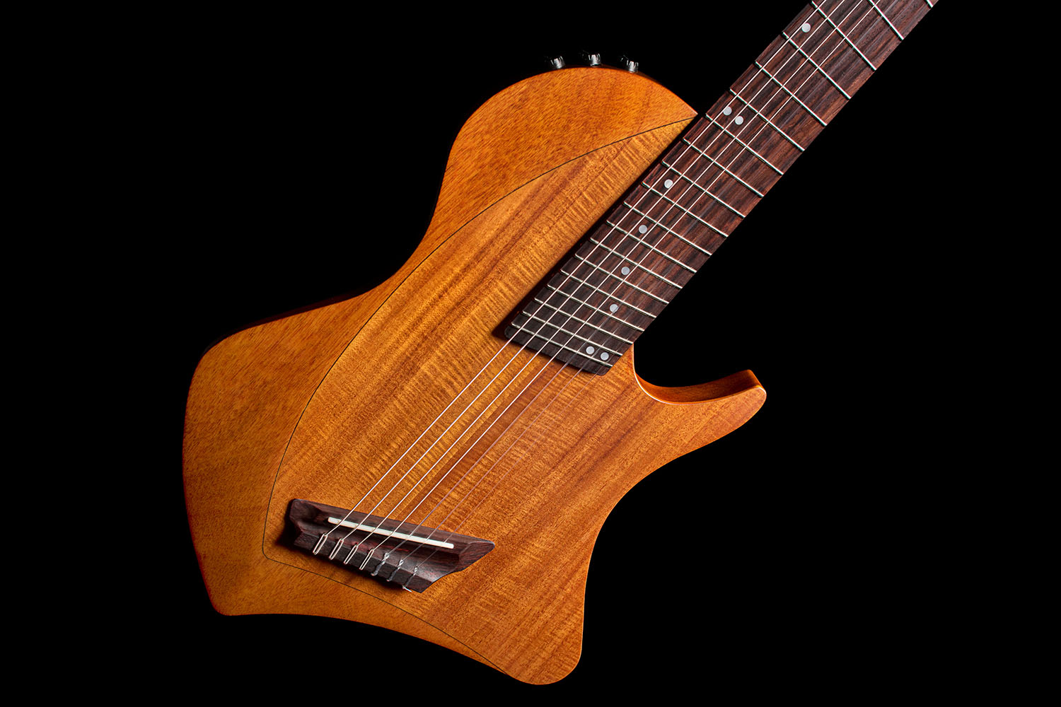 Front view of the Abasi Stage 7 Acacia's ergonomic double-cutaway solidbody, showing the side-mounted control knob.