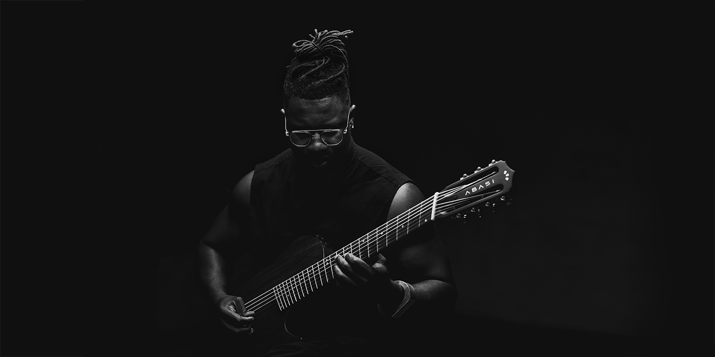 Tobin Abasi playing an Abasi guitar.
