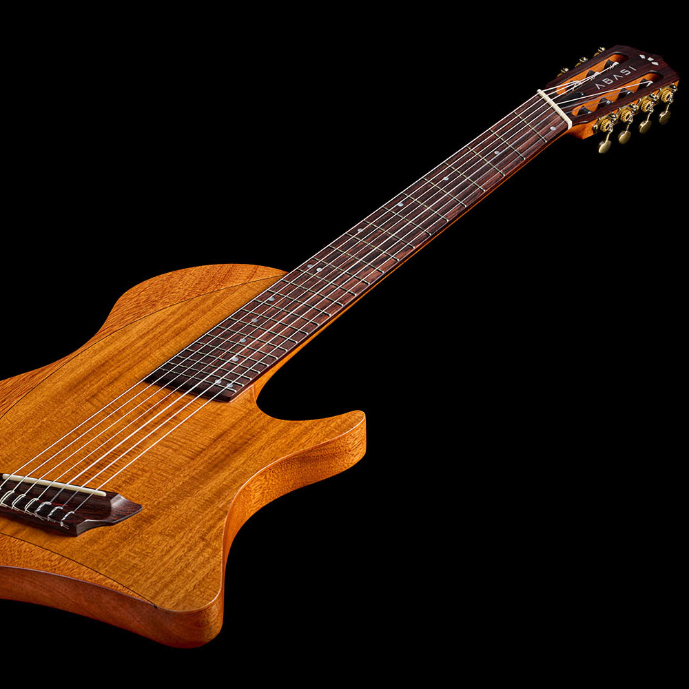 Angled view down the Abasi Stage 7 Acacia's neck, showing the fretboard binding and fanned frets leading to the headstock.