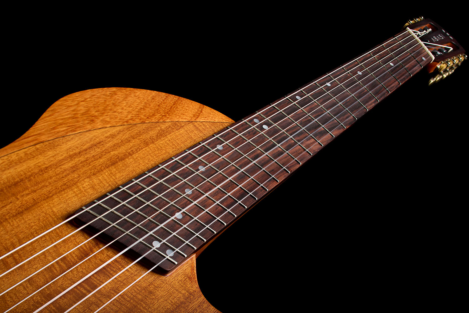 View looking down the fanned-fret neck of the Abasi Stage 7 Acacia from the headstock toward the body.