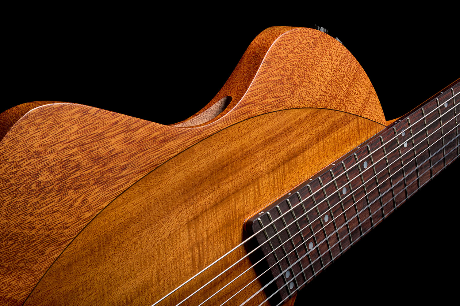 Angled top-down view of the Abasi Stage 7 Acacia's body, showing the acacia veneer top, bridge, and side-mounted controls.