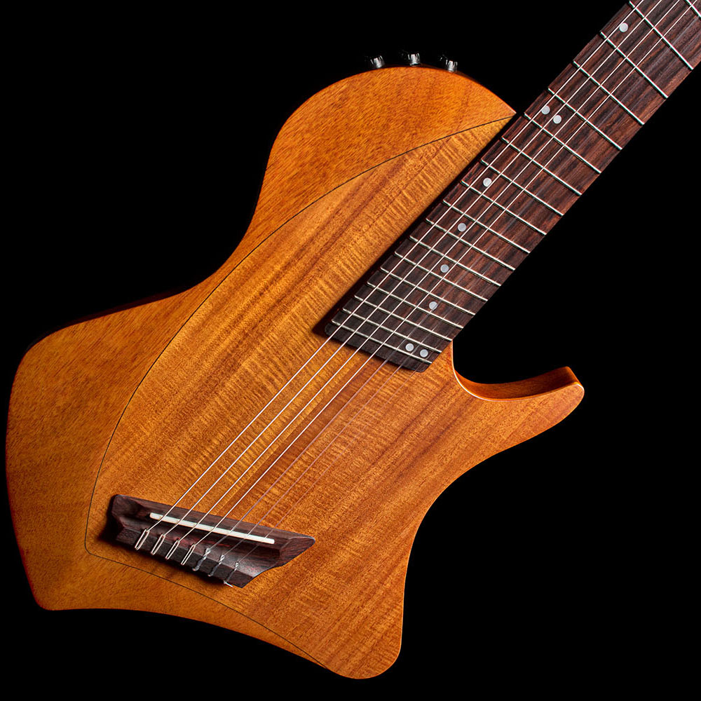 Front view of the Abasi Stage 7 Acacia's ergonomic double-cutaway solidbody, showing the side-mounted control knob.