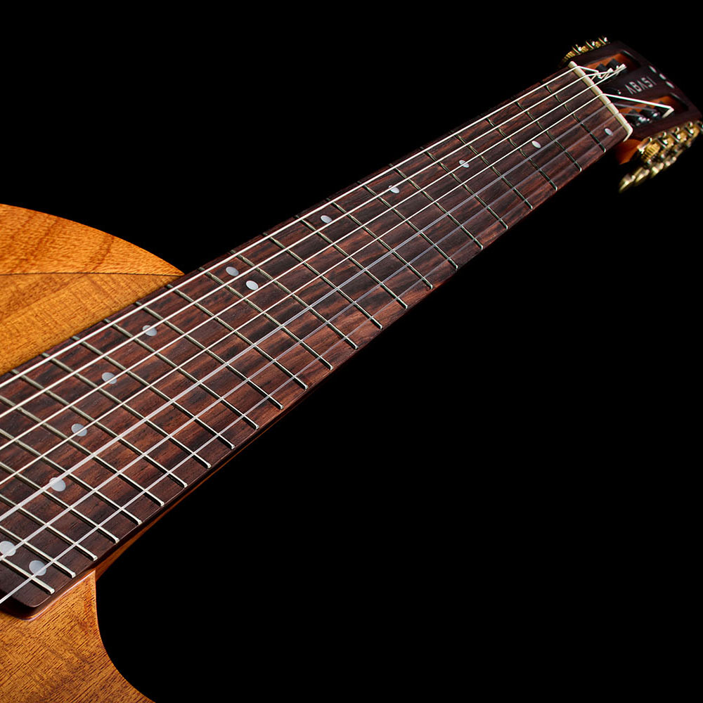 View looking down the fanned-fret neck of the Abasi Stage 7 Acacia from the headstock toward the body.