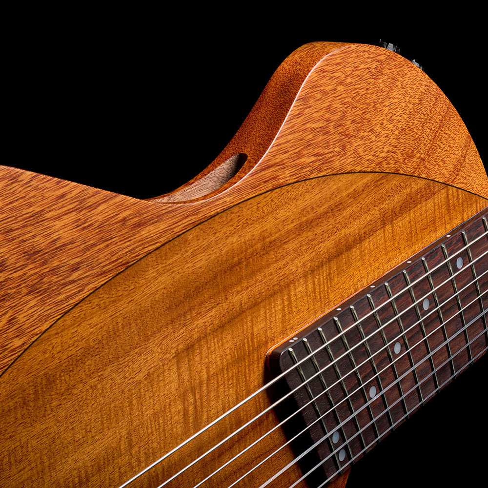 Angled top-down view of the Abasi Stage 7 Acacia's body, showing the acacia veneer top, bridge, and side-mounted controls.