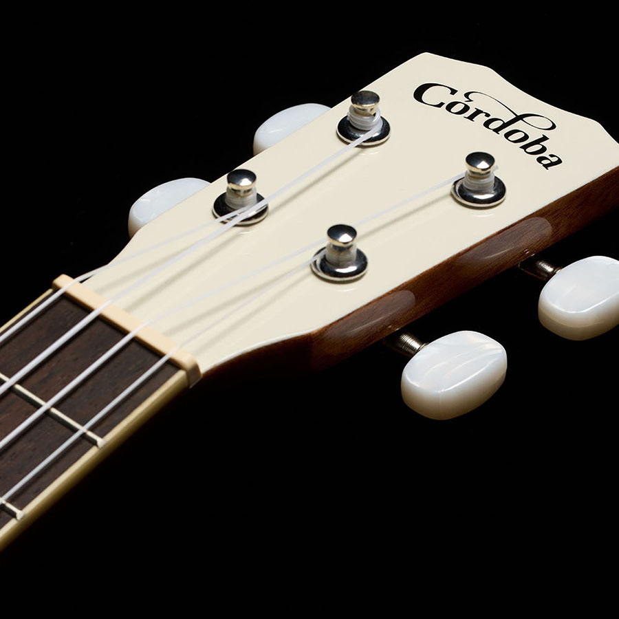 Close-up view of Córdoba 15C Mallorcan Pearl ukulele headstock thumb