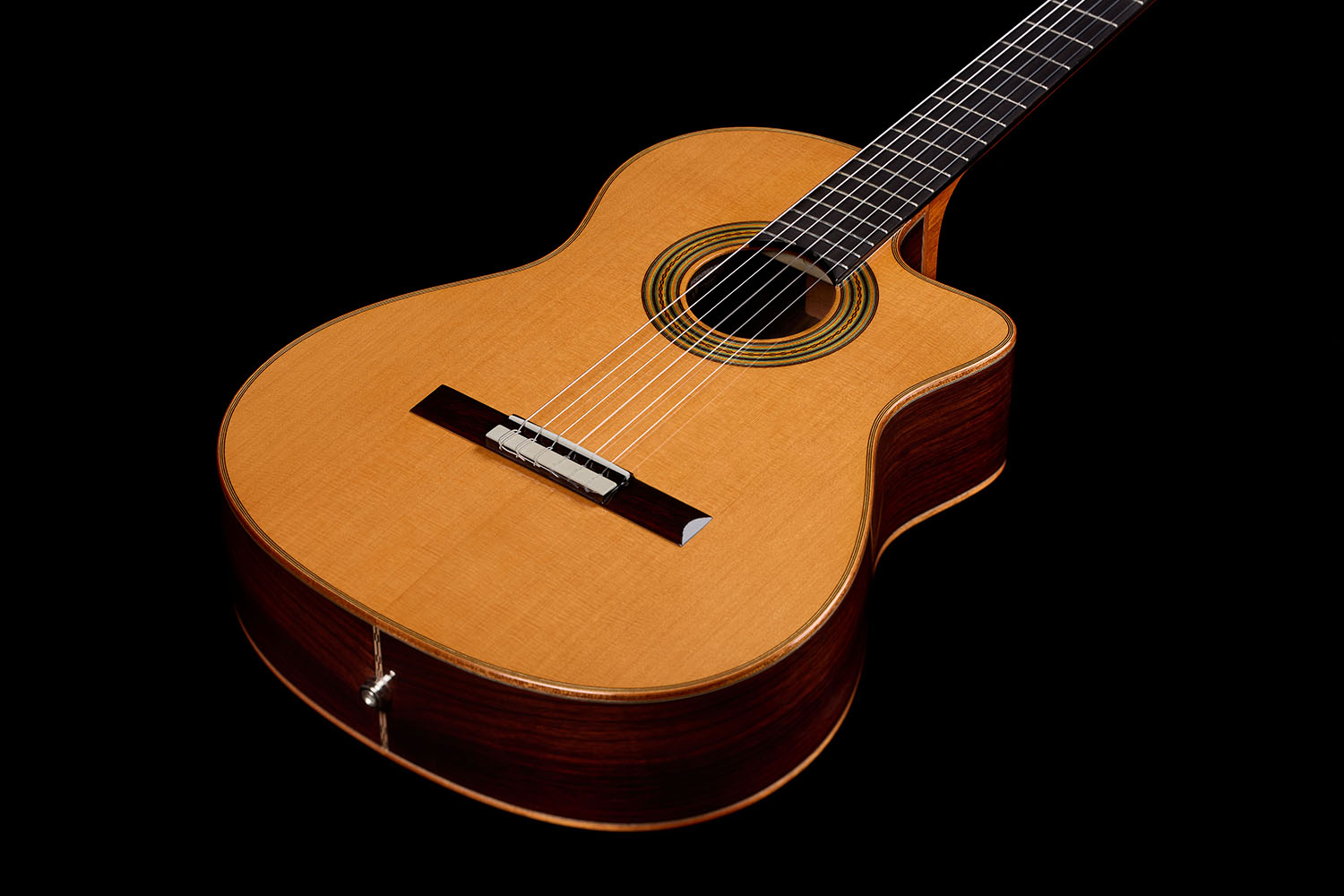 Front view of the cutaway body and neck, showing the cedar top, bridge, and rosette-ringed soundhole of the Orchestra CE Pro.